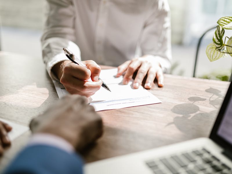 Professional notary signing documents at desk in Gatesville, Texas